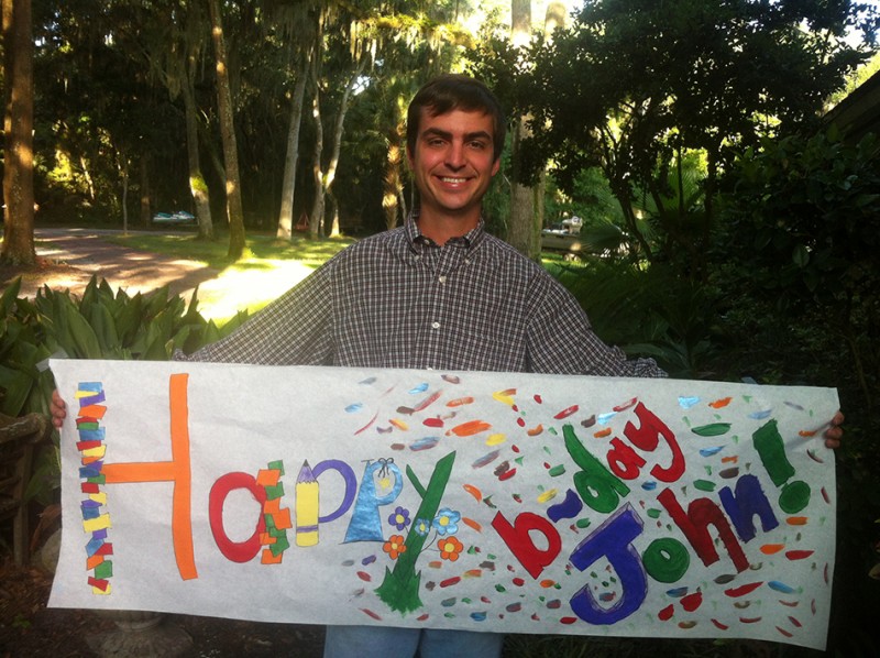 John III holding the birthday banner his little sister made for him.